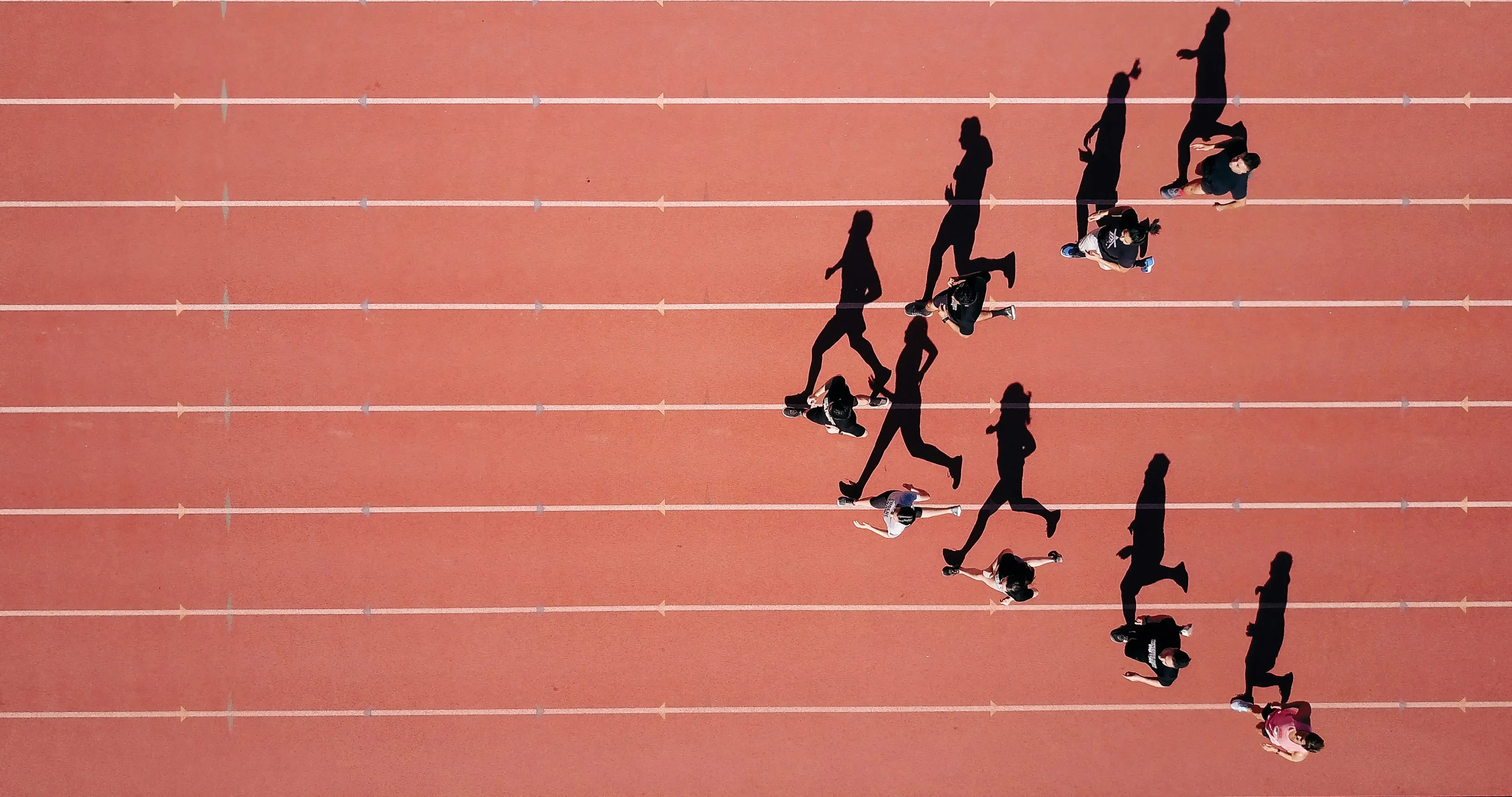 People running on a red path.